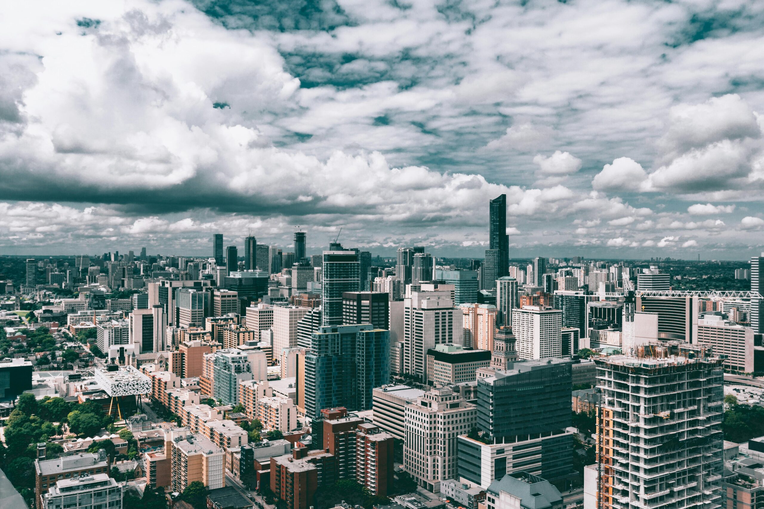 Dynamic cityscape featuring towering skyscrapers and a vibrant urban skyline under a cloudy sky.